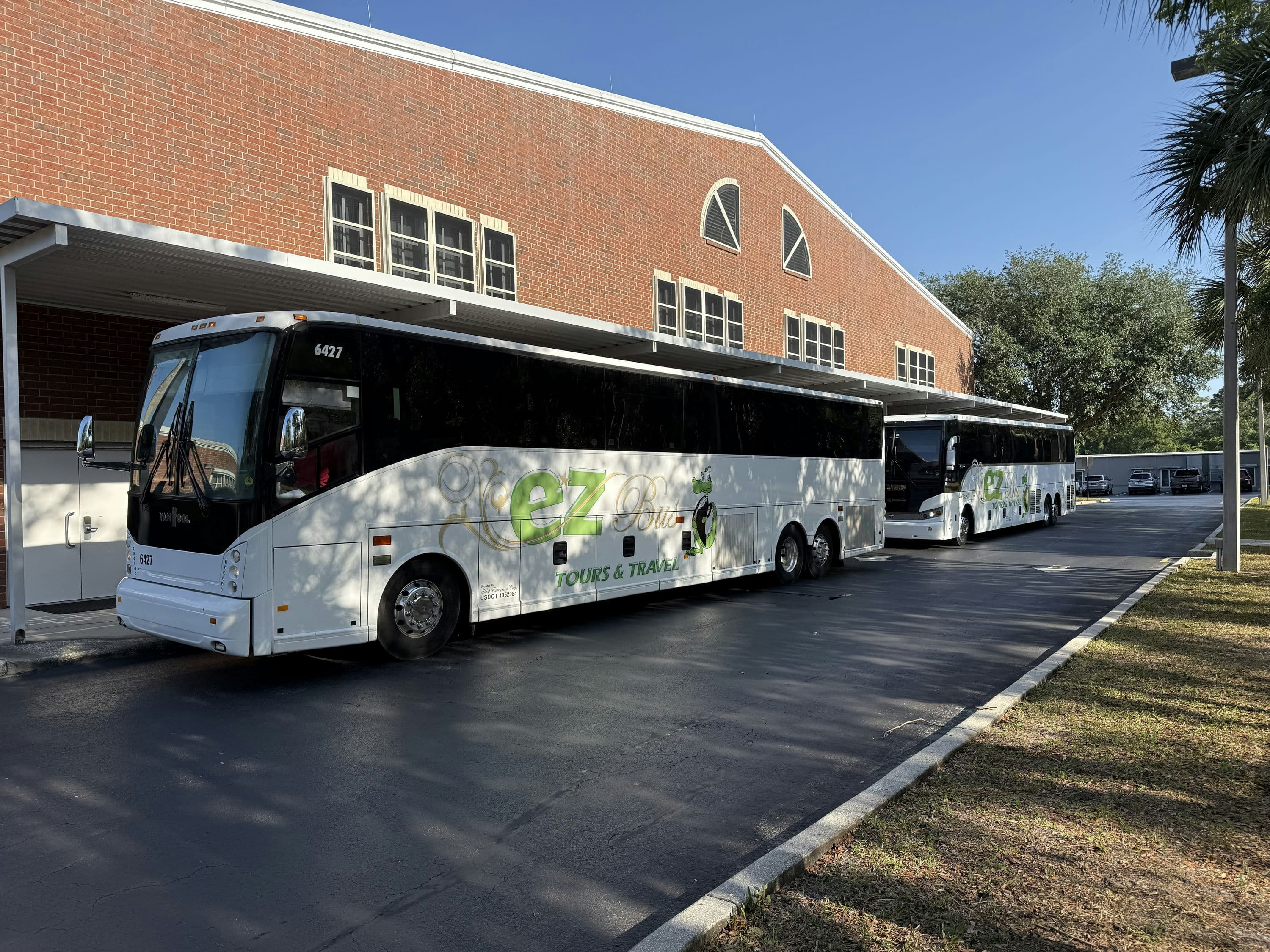 EZ Bus coaches parked at a school pickup