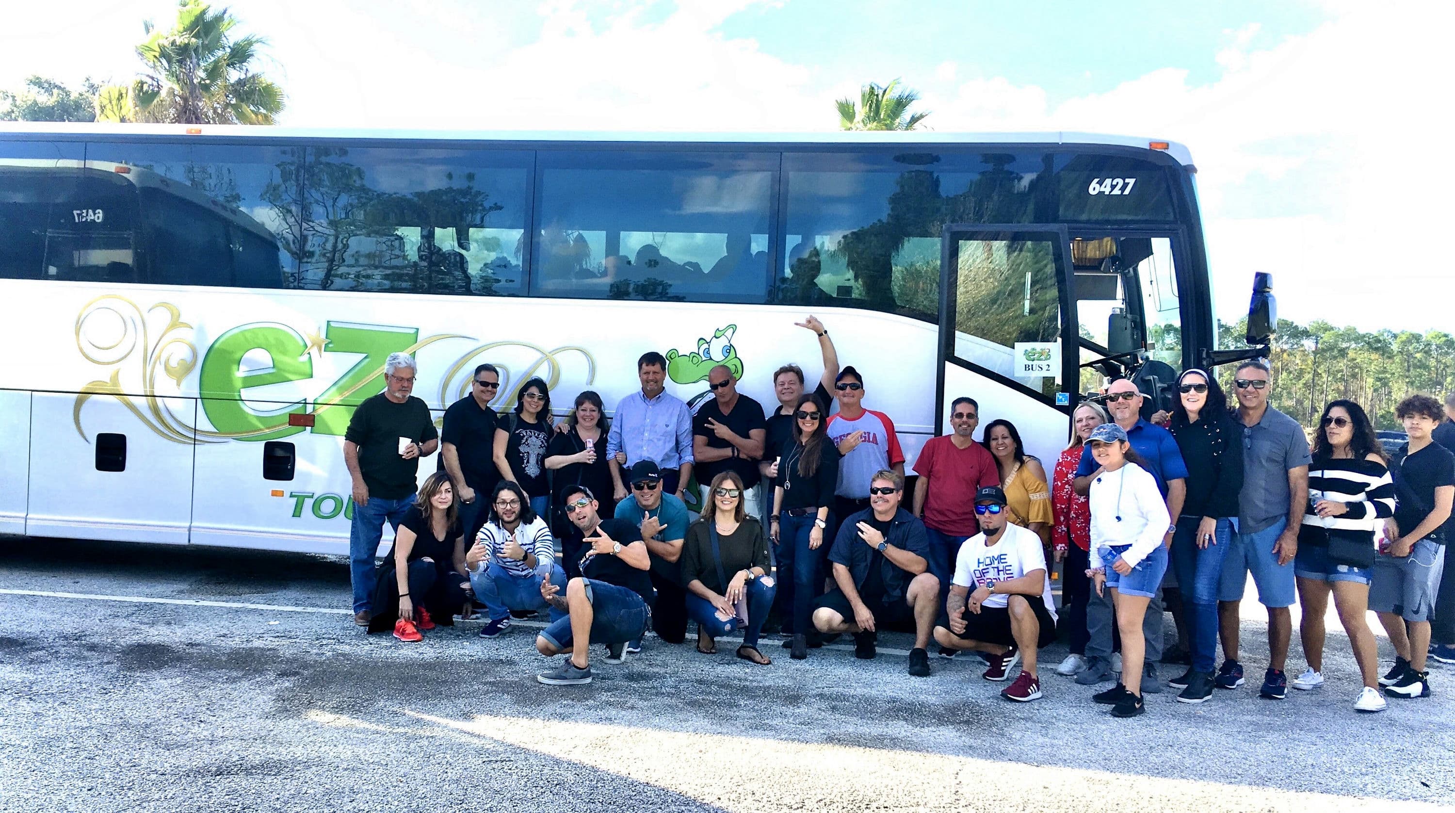 A community group posing with their EZ Bus coach on a day trip